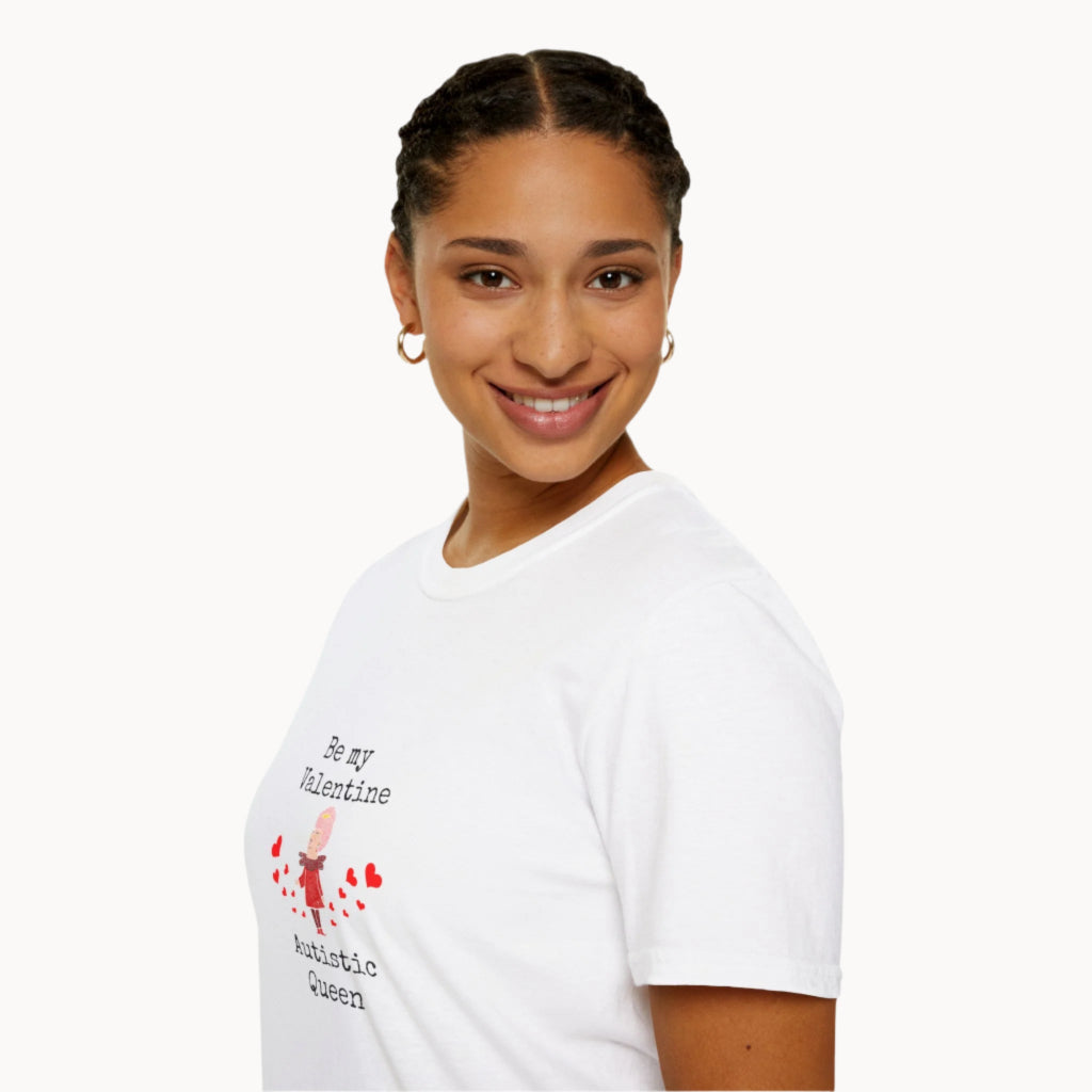 Smiling woman wearing white Be My Valentine Autistic Queen T-Shirt with black letters and red hearts and cartoon queen image on front