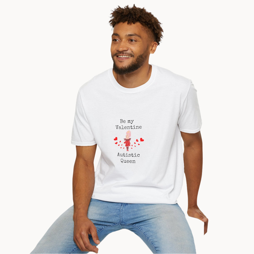Sitting man wearing White Be My Valentine Autistic Queen T-Shirt with black letters and red hearts and cartoon queen image on front